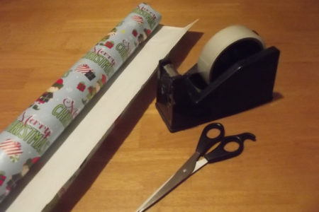 Wrapping Christmas Presents With Sellotape, Scissors And Wrapping Paper