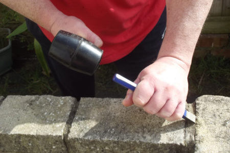 Man Using A Rubber Mallet And Chisel